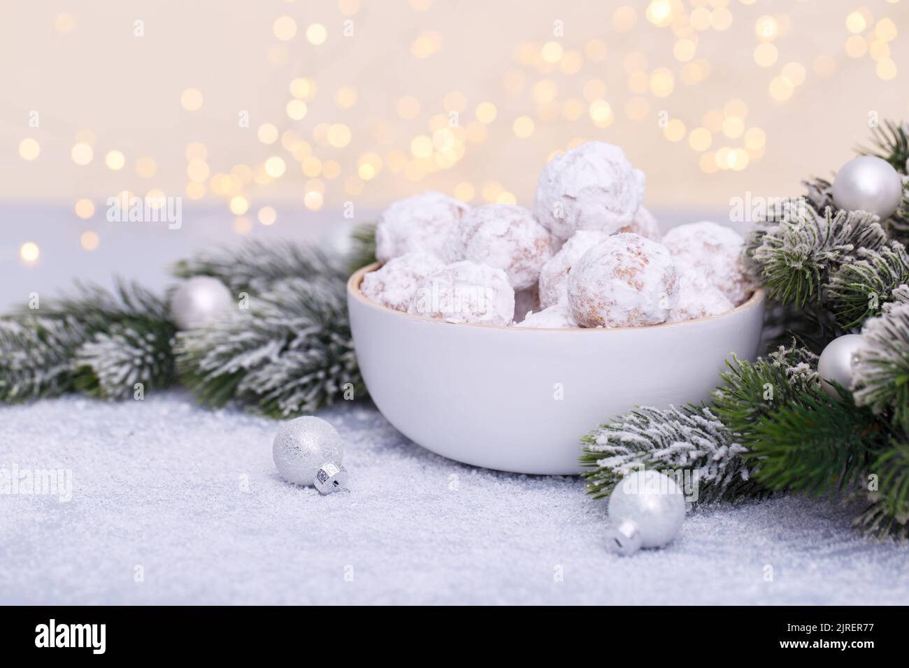 Traditional Christmas snowball cookies with almonds on snowy  background Stock Photo