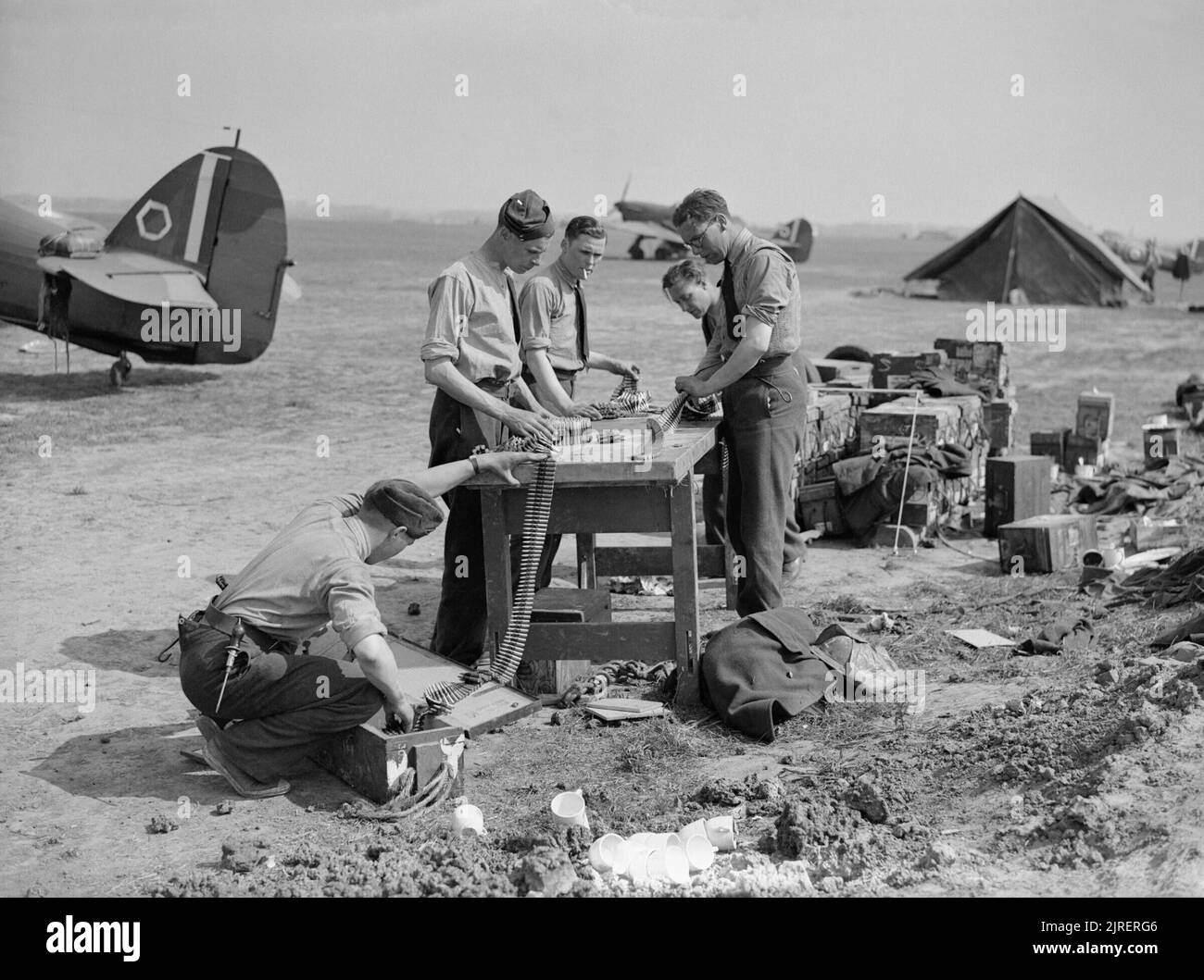 Royal Air Force- France, 1939-1940. Ground crew and armourers refill ammunition belts with .303 bullets by Hawker Hurricane Mark Is of No. 85 Squadron RAF at Lille-Seclin. Stock Photo