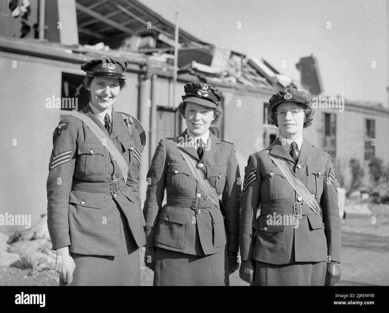 Royal Air Force Fighter Command, 1939-1945. Sergeant Joan E Mortimer, Flight Officer Elspeth C Henderson and Sergeant Helen E Turner, recipients of the Military Medal for gallantry, standing outside damaged buildings at Biggin Hill, Kent. All three were WAAF teleprinter operators who stayed at their posts and continued to work the defence lines during the heavy Luftwaffe attacks on Biggin Hill on 1 September 1940. Stock Photo