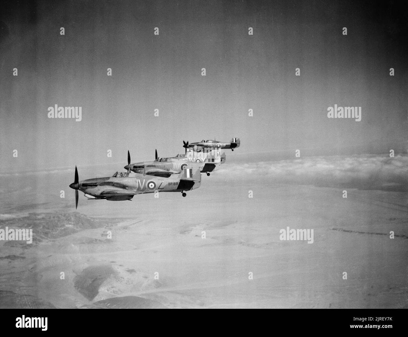 Royal Air Force Operations in the Middle East and North Africa, 1939-1943. Four Hawker Hurricane Mark IIDs (BP188 'JV-C' nearest), of No. 6 Squadron RAF based at Shandur, Egypt, flying in starboard echelon formation over the Western Desert. Stock Photo
