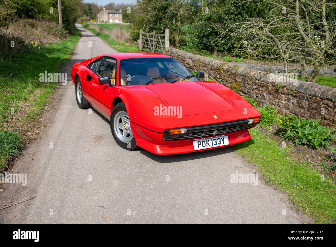 Ferrari 308 parked on a country lane on a sunny day Stock Photo