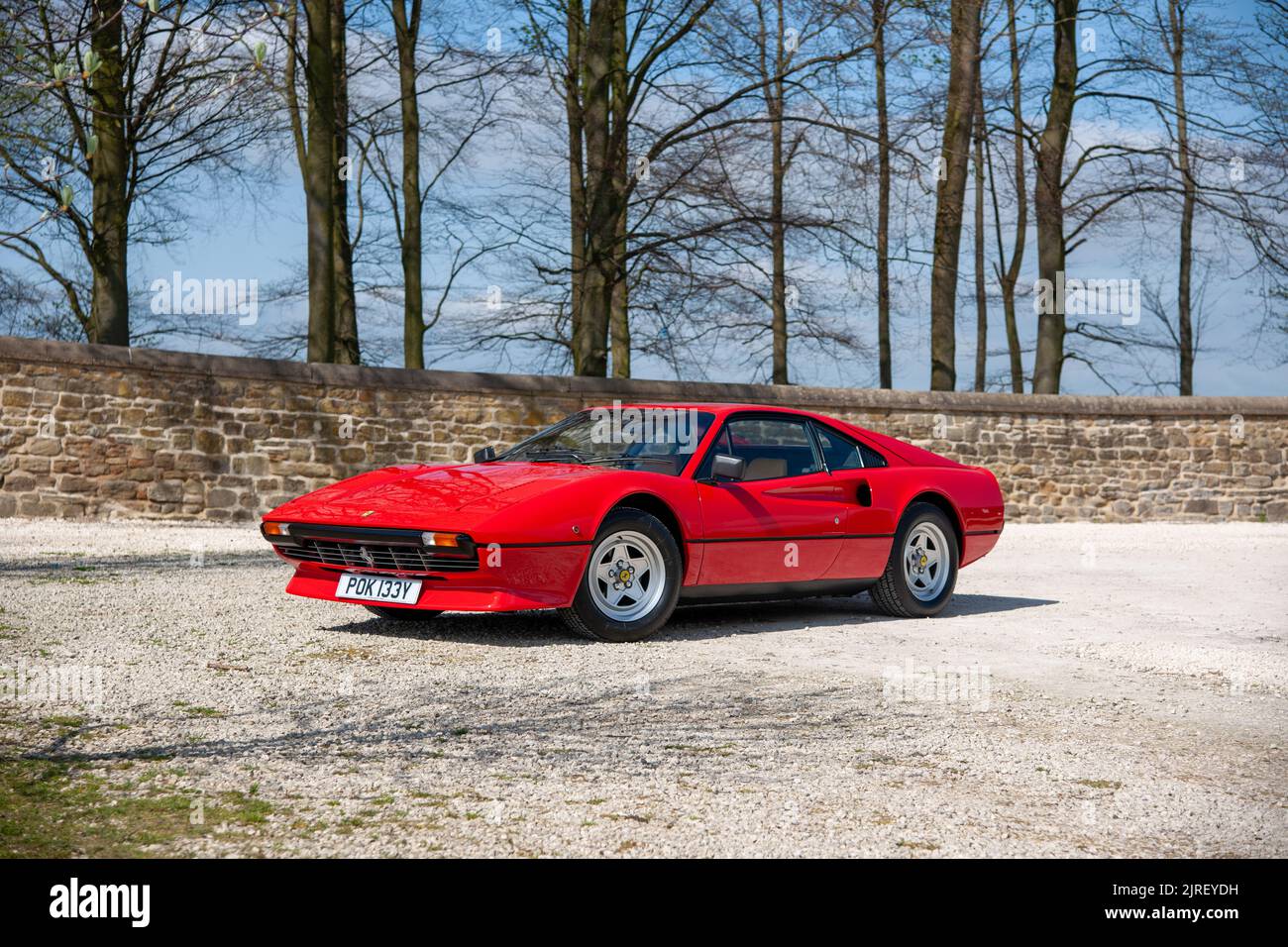Ferrari 308 parked on a gravel courtyard on a sunny day Stock Photo