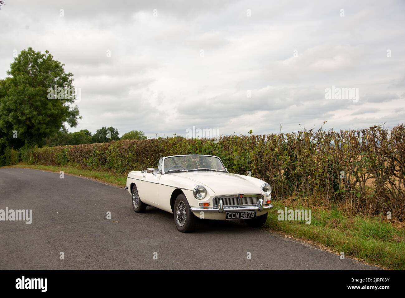 Chrome bumper MGB roadster British classic car parked on a country lane
