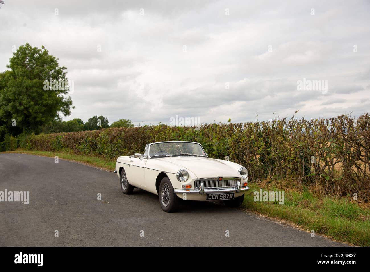 MGB roadster British classic car parked on a country lane in the Peak District, Derbyshire, UK Stock Photo