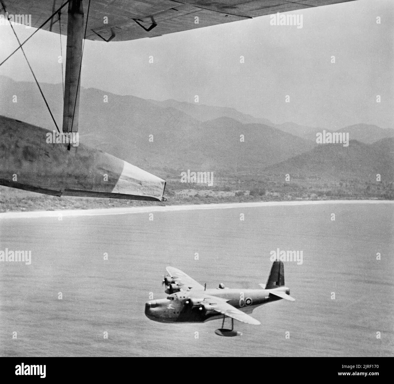 Royal Air Force- West Africa Command, 1941-1945. A Short Sunderland Mark III of No. 95 Squadron RAF, based at Jui, Sierra Leone, flying along the coast of West Africa on a patrol, photographed from another aircraft of the Squadron. Stock Photo