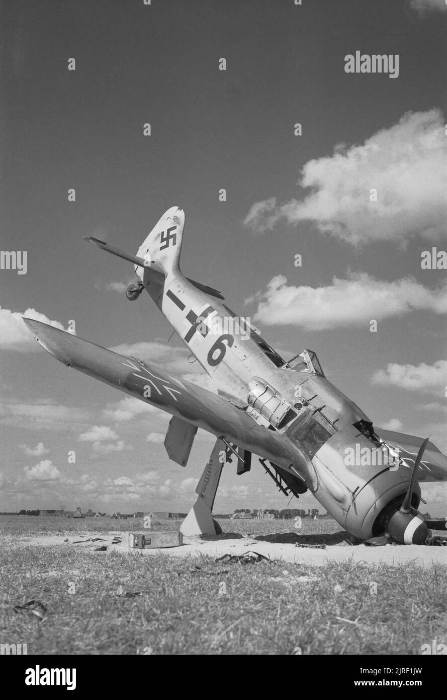 The German Retreat in Belgium, September 1944 A German Focke-Wulf FW 190A-8 fighter lies abandoned on an airfield liberated by British troops at Steen Okkerzeel, north east of Brussels, Belgium. Stock Photo