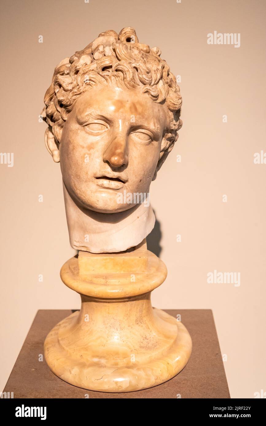 Close-up on marble head of ancient roman statue representing a young and handsome lad Stock Photo