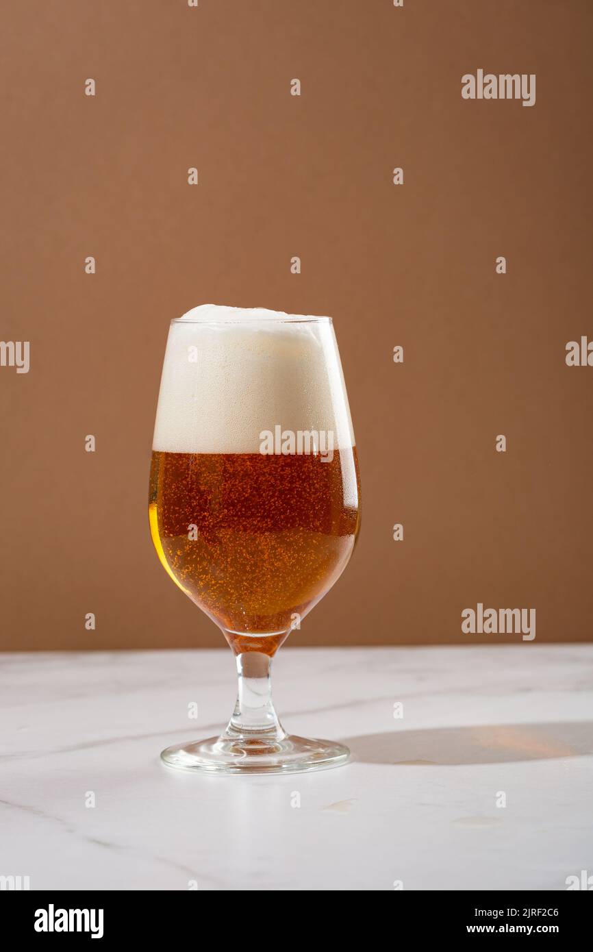 Close up of glass of light beer with foam on top  food and drink copy space Stock Photo
