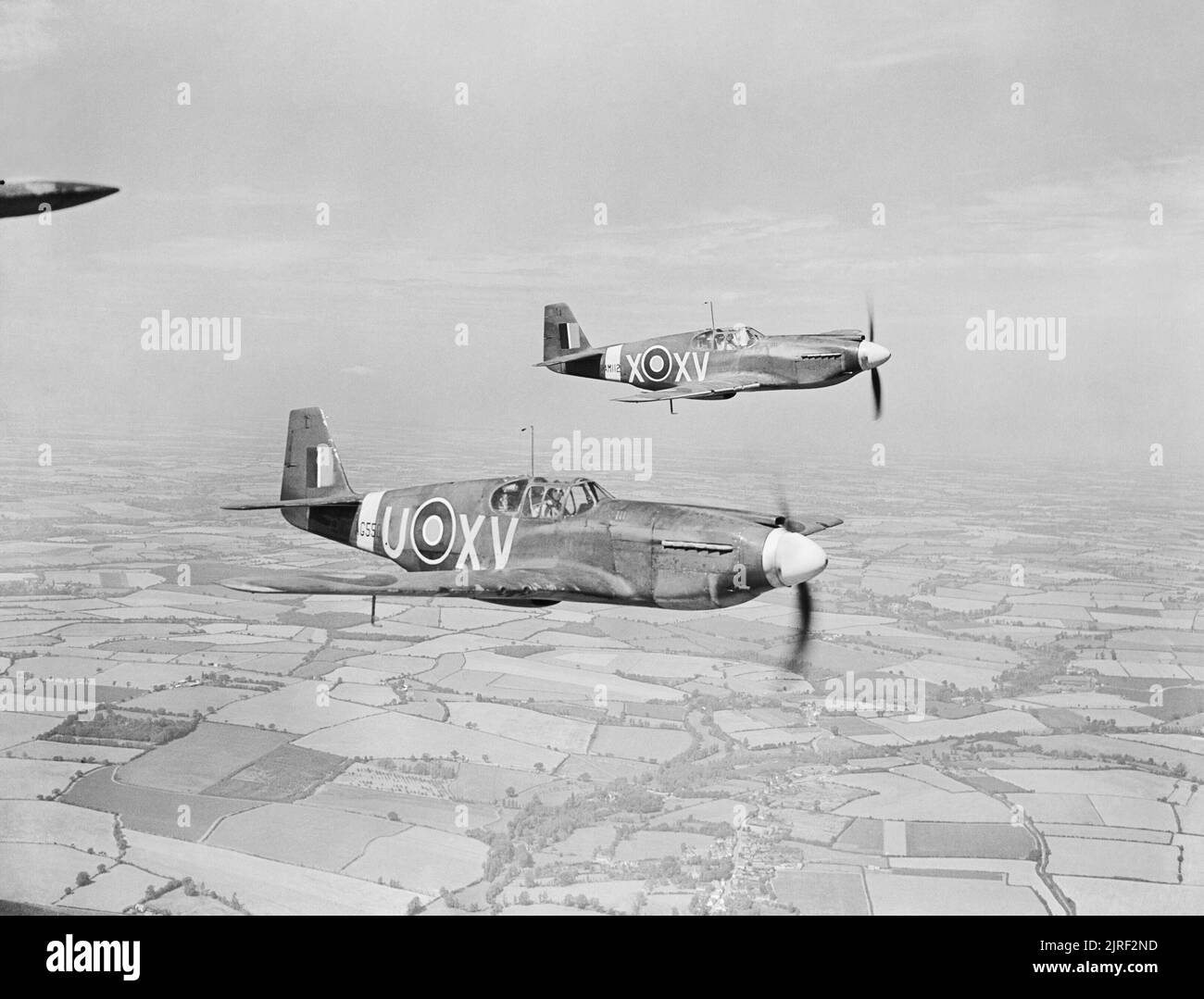 American Aircraft in Royal Air Force Service 1939-1945- North American Na 73 and Na 102 Mustang. Mustang Mark Is, AG550 ?XV-U? and AM112 ?XV-X?, of No. 2 Squadron RAF based at Sawbridgeworth, Hertfordshire, in flight over Cambridgeshire. AG550 is being flown by Wing Commander A J W Geddes, the squadron commander. Stock Photo