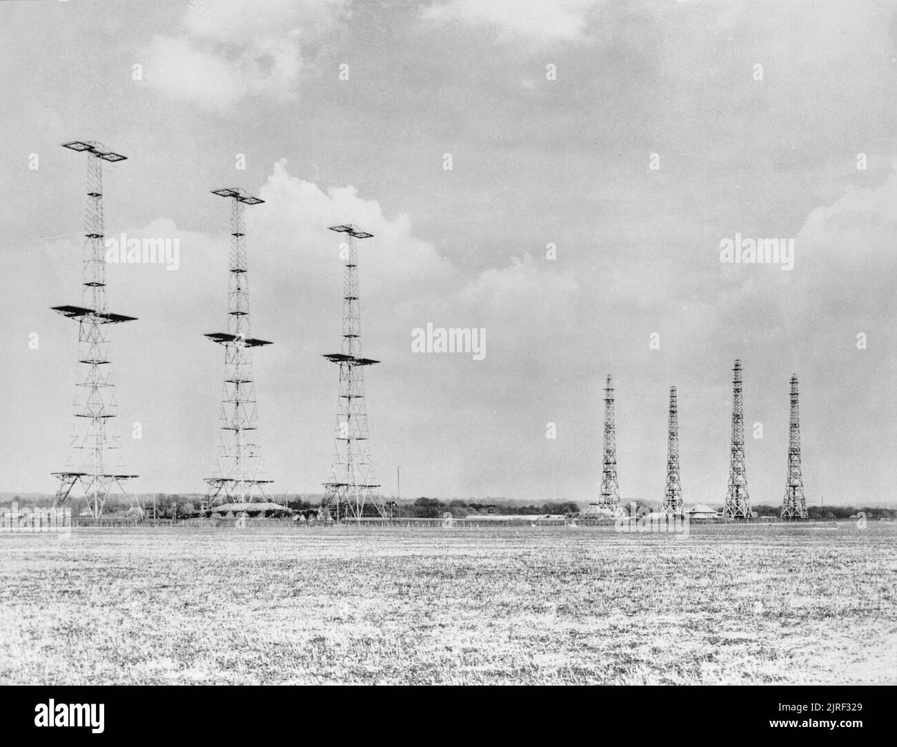 Chain Home radar installation at Poling, Sussex, 1945. Chain Home: AMES Type 1 CH East Coast radar installation at Poling, Sussex. On the left are three (originally four) in-line 360ft steel transmitter towers, between which the transmitter aerials were slung, with the heavily protected transmitter building in front. On the right are four 240ft wooden receiver towers placed in rhombic formation, with the receiver building in the middle. Stock Photo