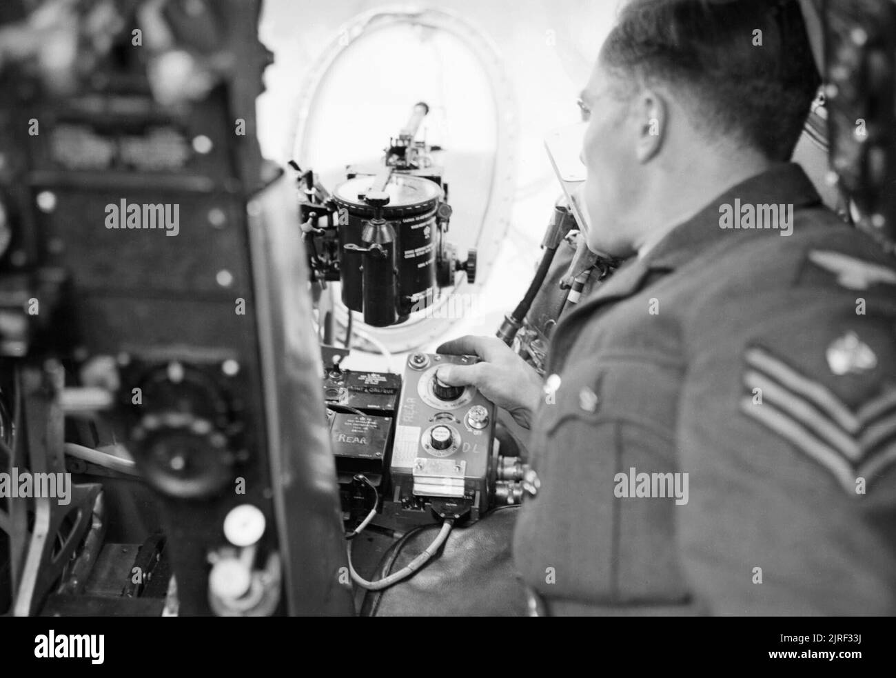 A ground crew sergeant demonstrates the operation of the photo-reconnaissance camera in a de Havilland Mosquito of No. 540 Squadron RAF at Benson, Oxfordshire, August 1943. Stock Photo