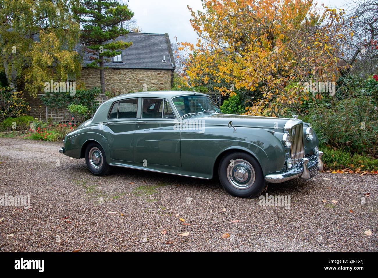 Bentley S1 saloon parked on a gravel drive in front of a house on an