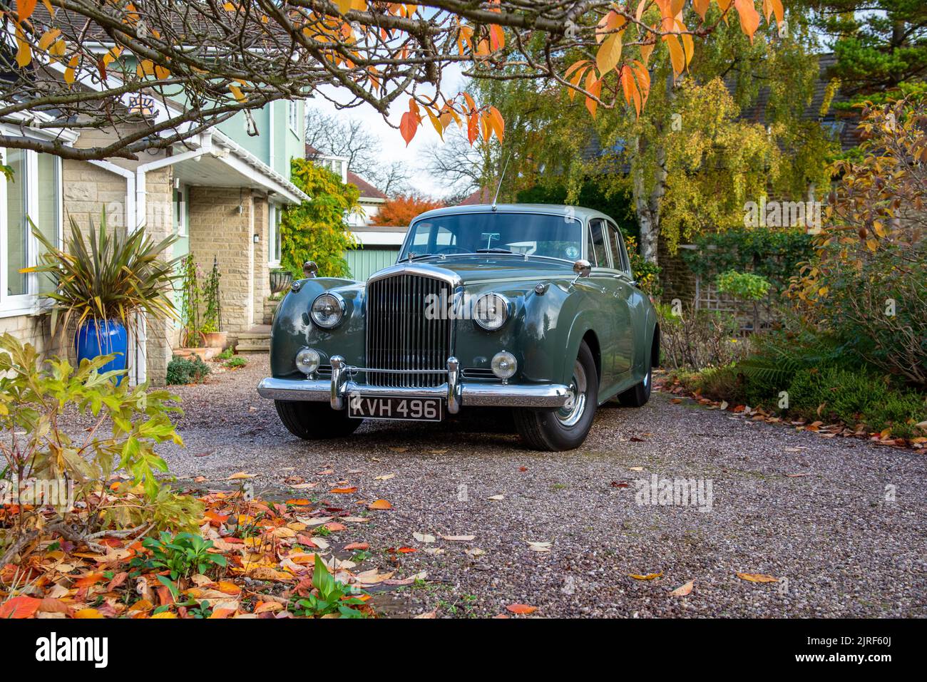 Bentley S1 saloon parked on a gravel drive in front of a house on an