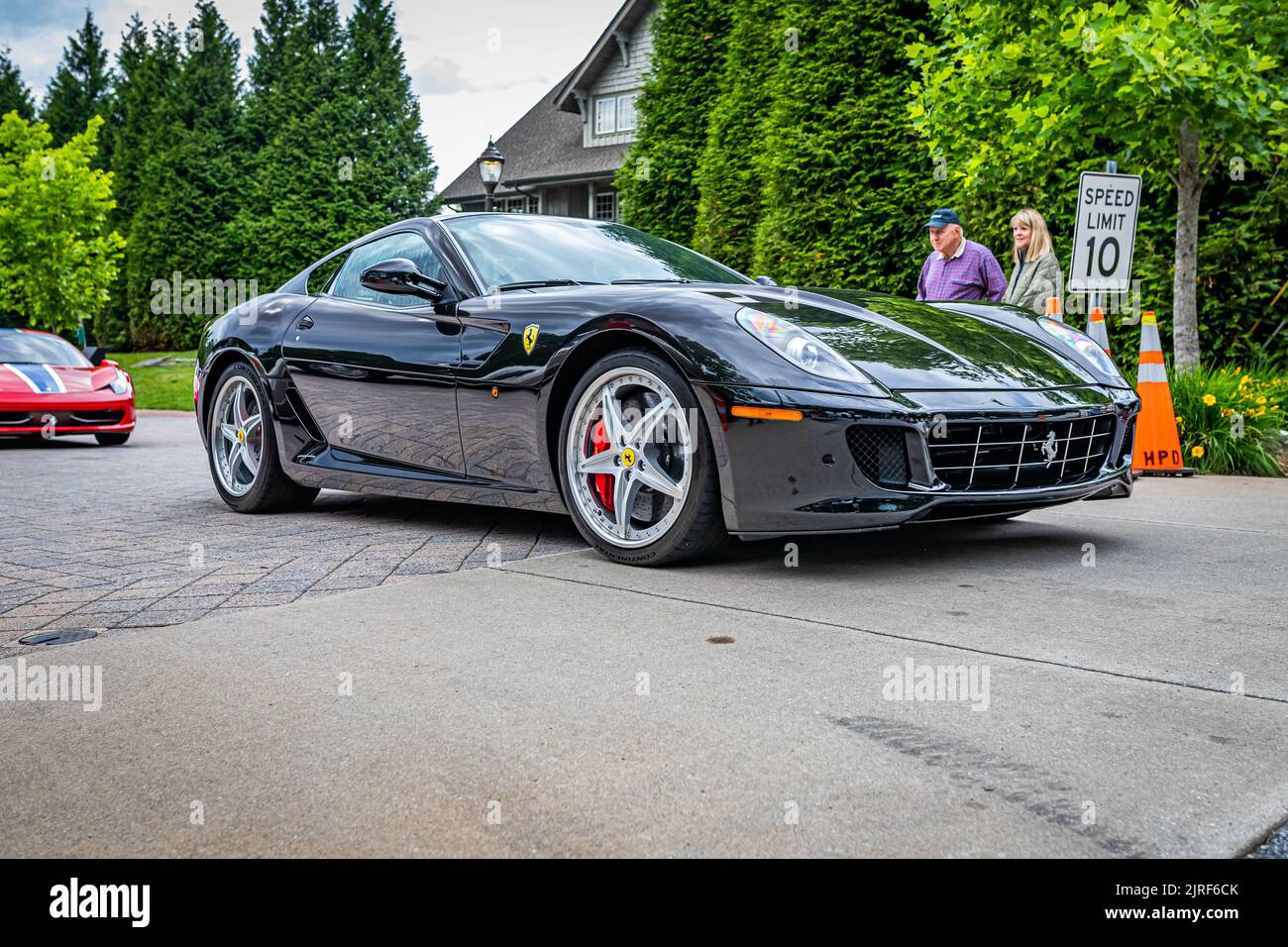 Highlands, NC - June 10, 2022: Low perspective front corner view of a 2010 Ferrari 599 GTB Fiorano HGTE leaving  a local car show. Stock Photo