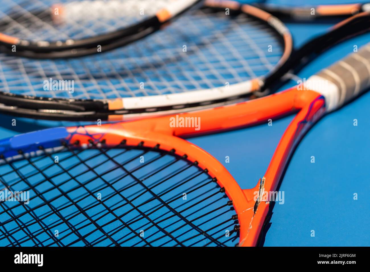 broken tennis rackets blue tennis court Stock Photo Alamy