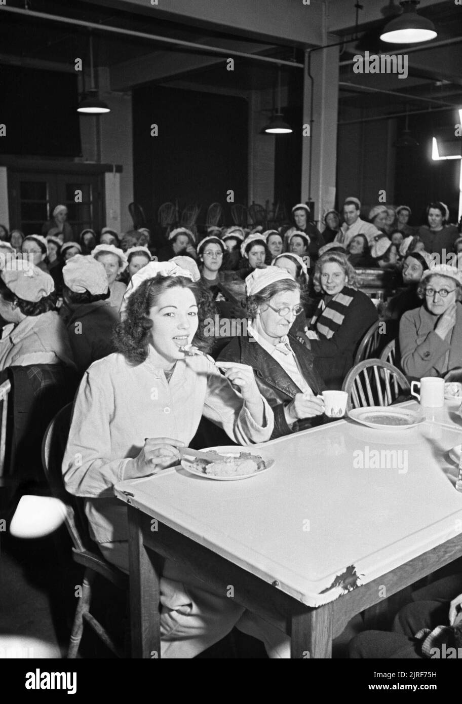 A new recruit to a shell filling factory enjoys lunch in the canteen