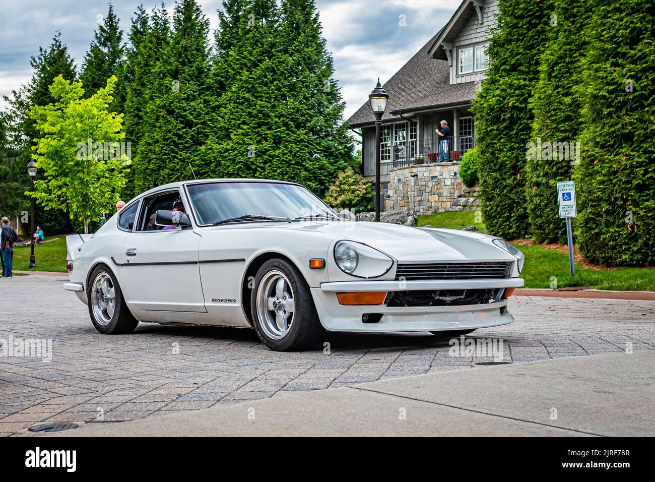 Highlands, NC - June 10, 2022: Low perspective front corner view of a 1972 Datsun 240Z Hardtop Coupe leaving a local car show. Stock Photo
