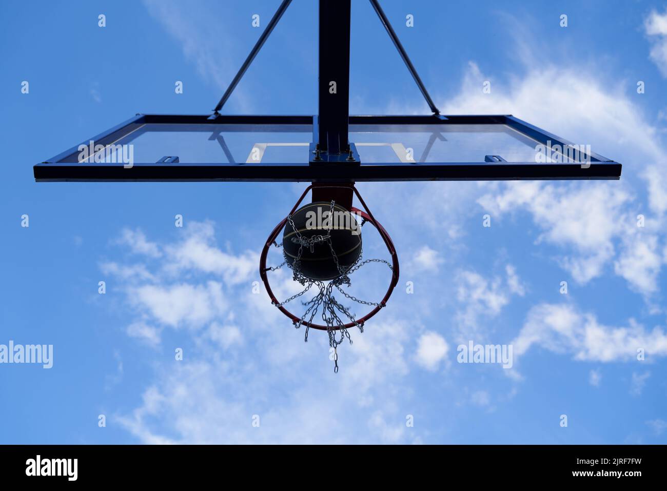 Street basketball ball falling into the hoop. Urban youth game. Concept