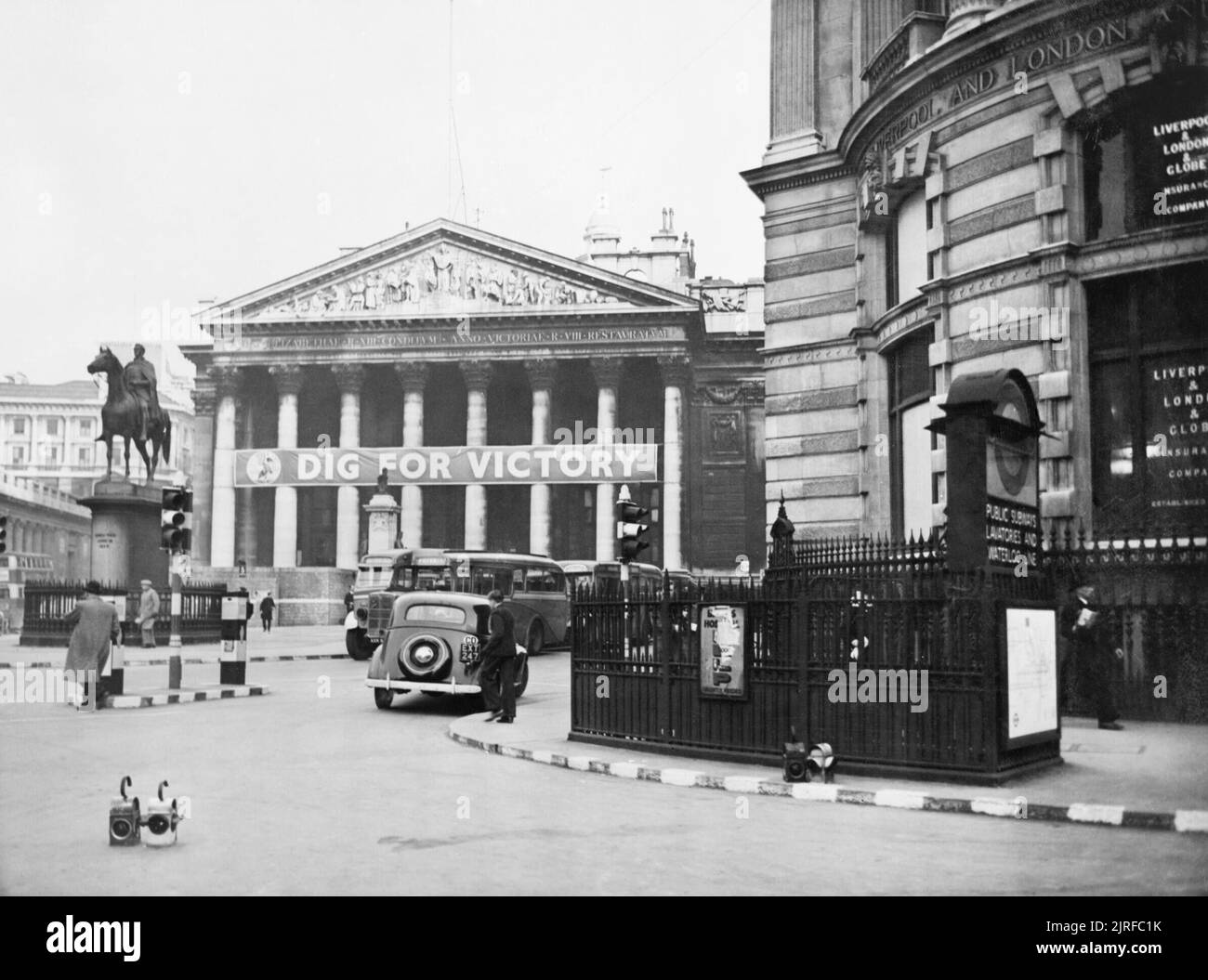 The Royal Exchange in London in use as a Ministry of Information 'special poster site' with a 'Dig for Victory banner' across the entrance in 1940. A view of the Royal Exchange in London, which was used as a Ministry of Information 'special poster site'. A 'Dig for Victory banner' is hanging across the columns at the front. Stock Photo