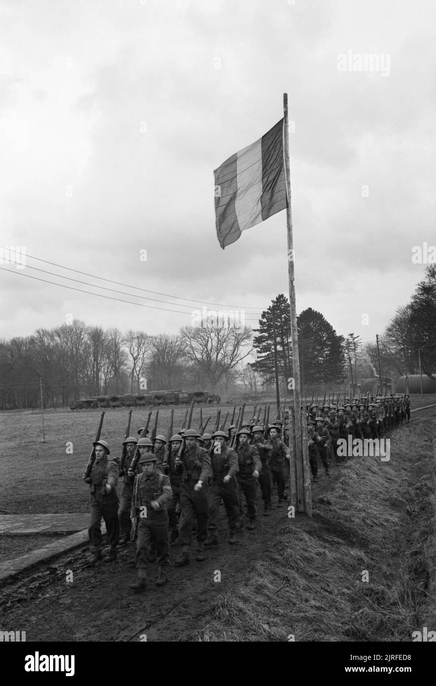 Belgian Commandos in Training, UK, 1945 A company of the 2nd Battalion, 2nd Belgian Brigade march past the Belgian flag during their Commando training, somewhere in Britain. Stock Photo