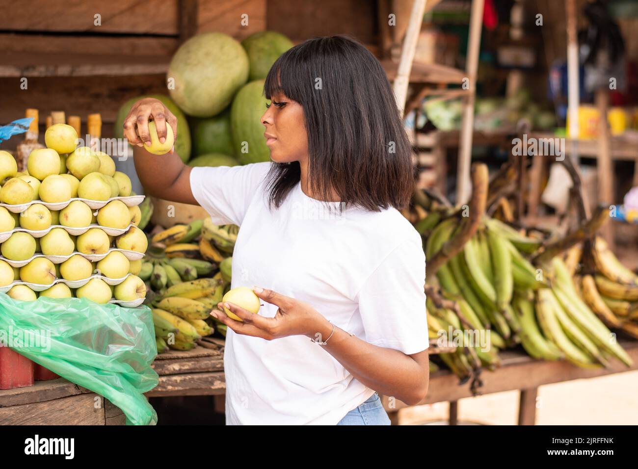pretty african lady shopping for apples Stock Photo Alamy