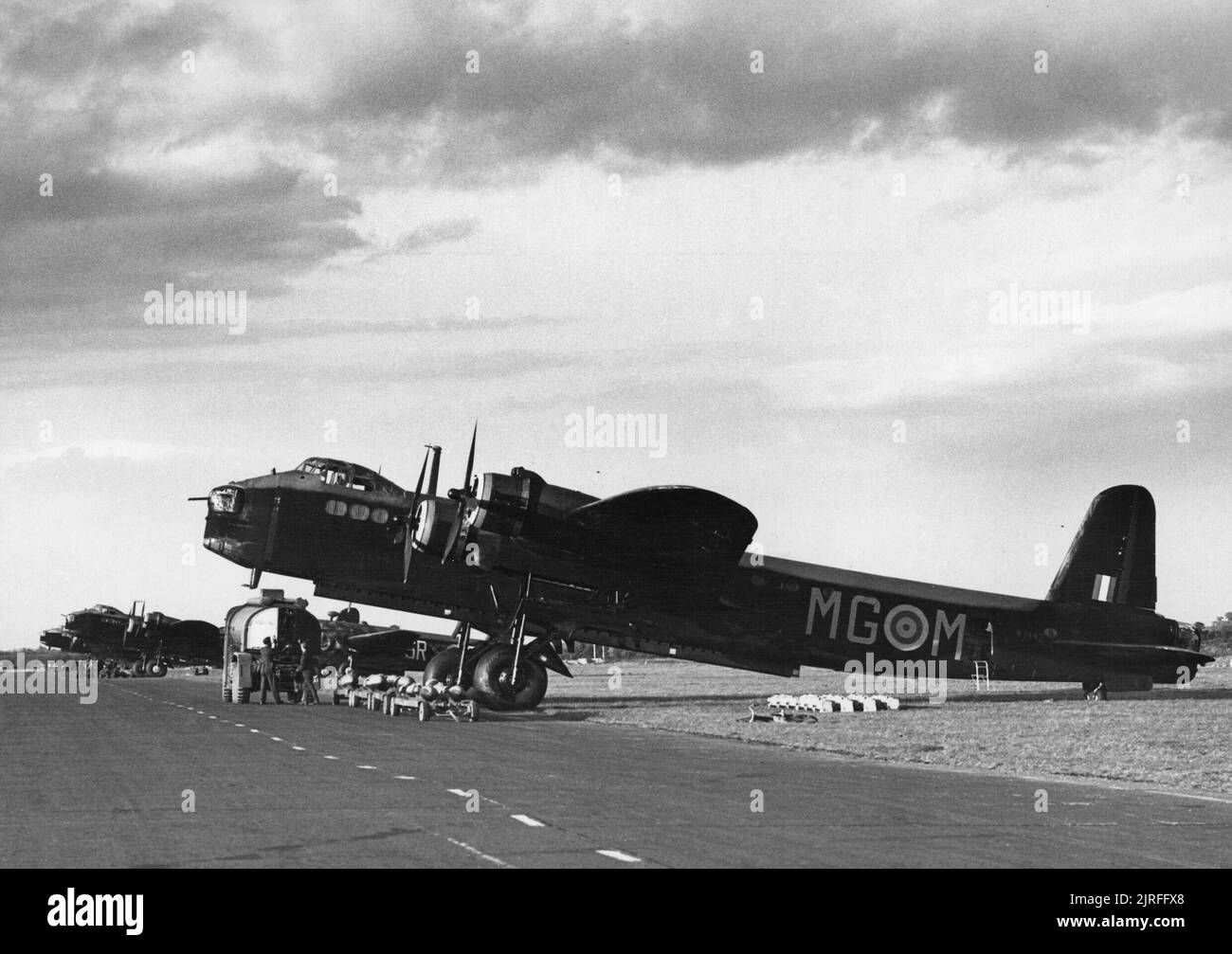 RAF Bomber Command Short Stirlings of No. 7 Squadron lined up at Oakington, October 1941. W7442 'MG-M' is in the foreground. A Wellington with No. 101 Squadron codes can also be seen in the background. Stock Photo