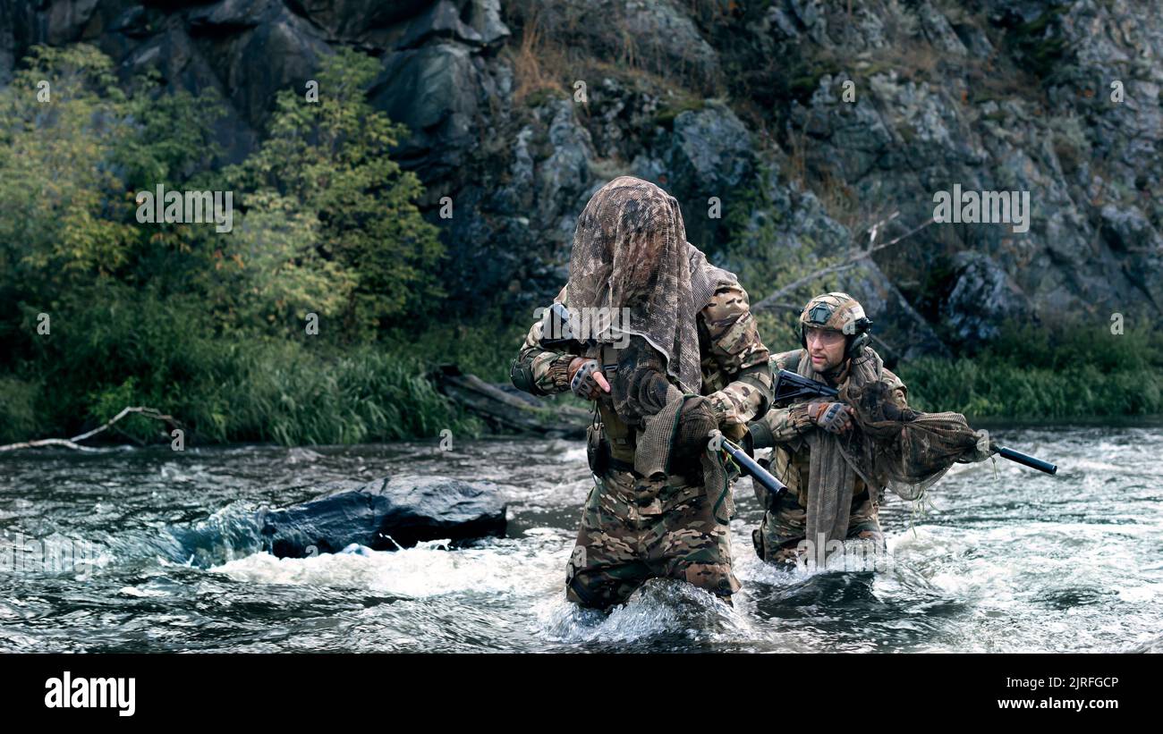 Photo of two mercenary soldiers crossing the river after the completion ...