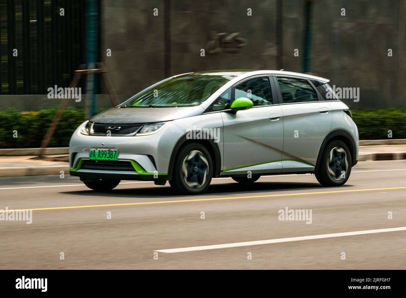 BYD Dolphin small electric hatchback car being driven on the road in