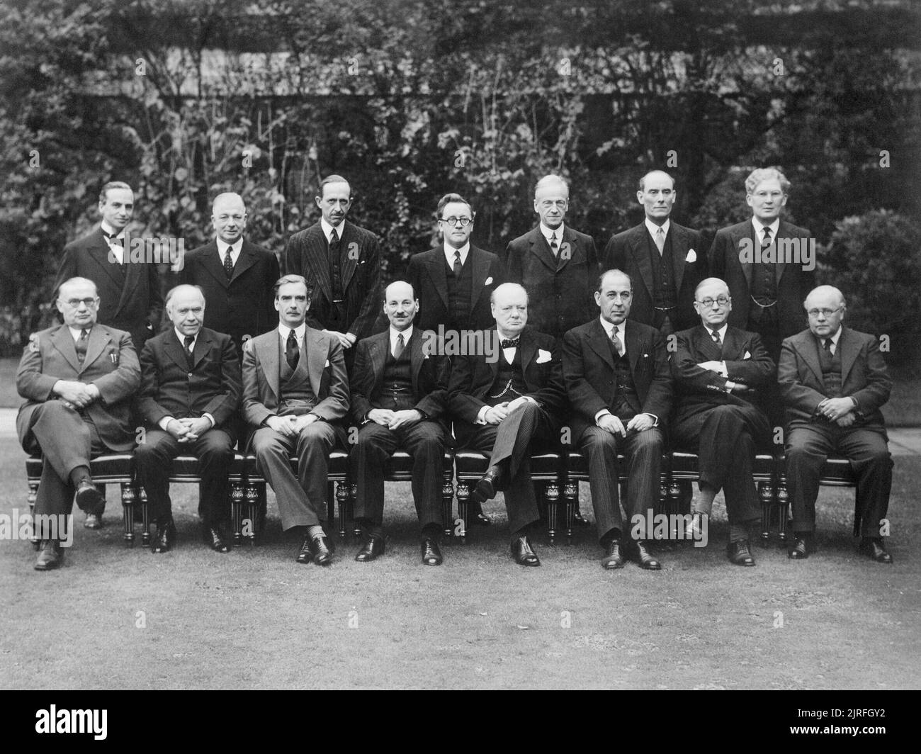 British Political Personalities 1936-1945 The Churchill Coalition Government 11 May 1940 - 23 May 1945: The Churchill Coalition War Cabinet: standing, from left to right, Sir Archibald Sinclair, Mr A V Alexander, Lord Cranborne, Herbert Morrison, Lord Moyne, Captain Margesson and Brendan Bracken. Seated, from left to right, Ernest Bevin, Lord Beaverbrook, Anthony Eden, Clement Attlee, Winston Churchill, Sir John Anderson, Arthur Greenwood and Sir Kingsley Wood. Stock Photo