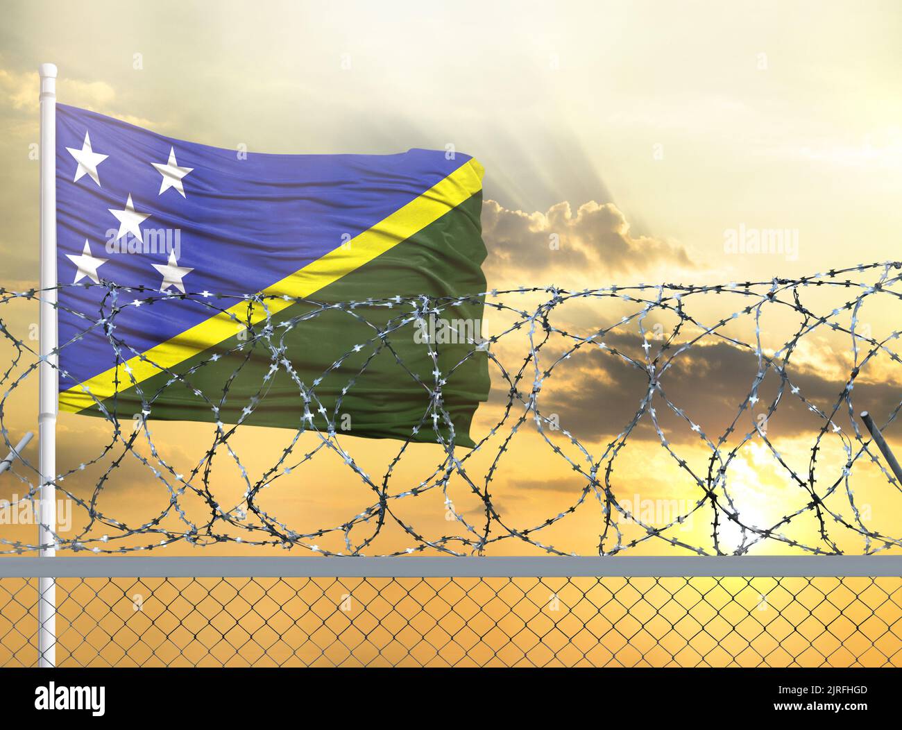 Flagpole with the flag of Solomon Islands against the sky and behind a ...