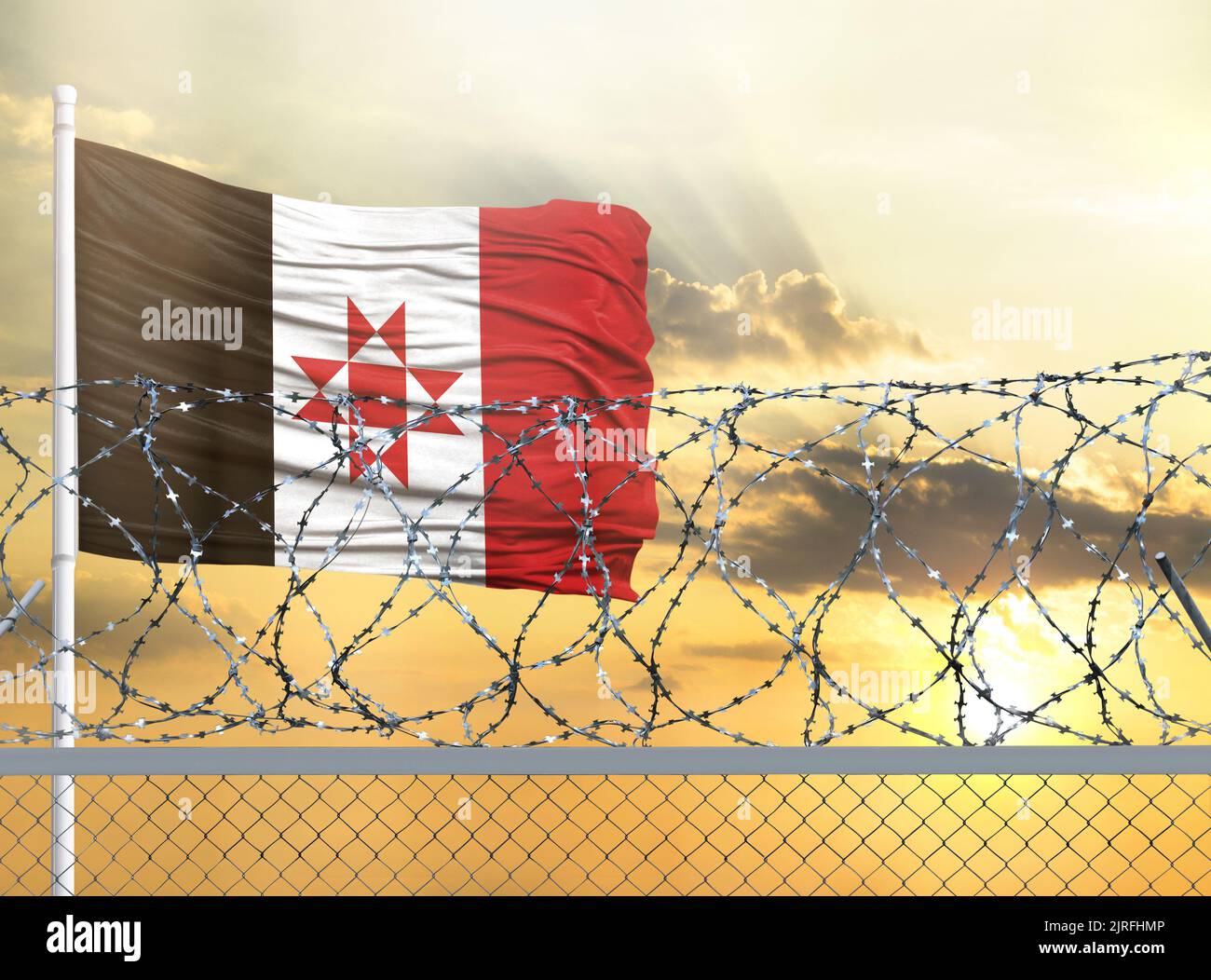 Flagpole with the flag of Udmurtia against the sky and behind a fence