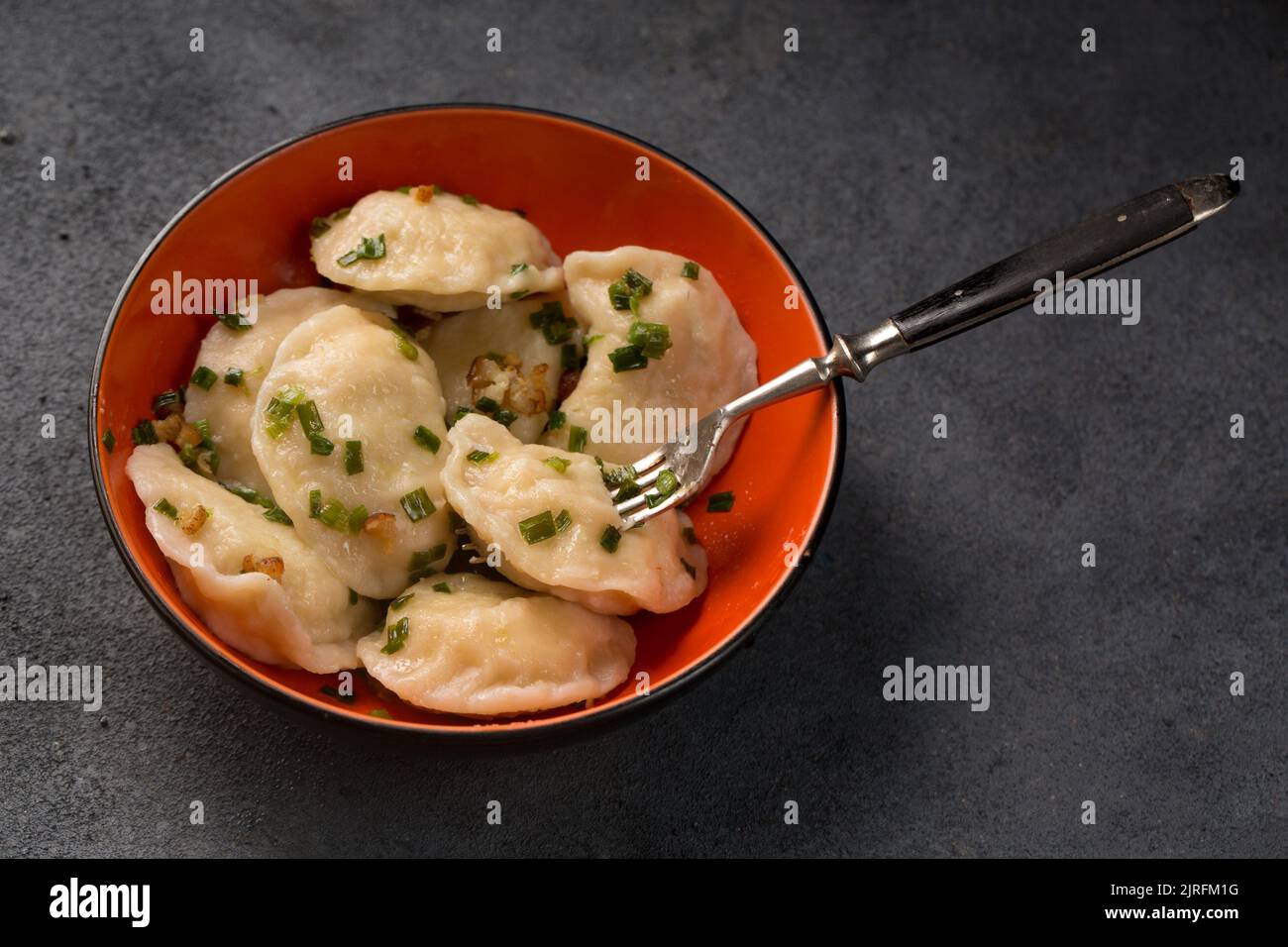 Potato dumplings with fried bacon and green onions Stock Photo Alamy