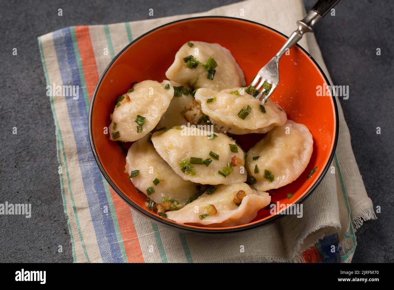 Potato dumplings with fried bacon and green onions Stock Photo Alamy