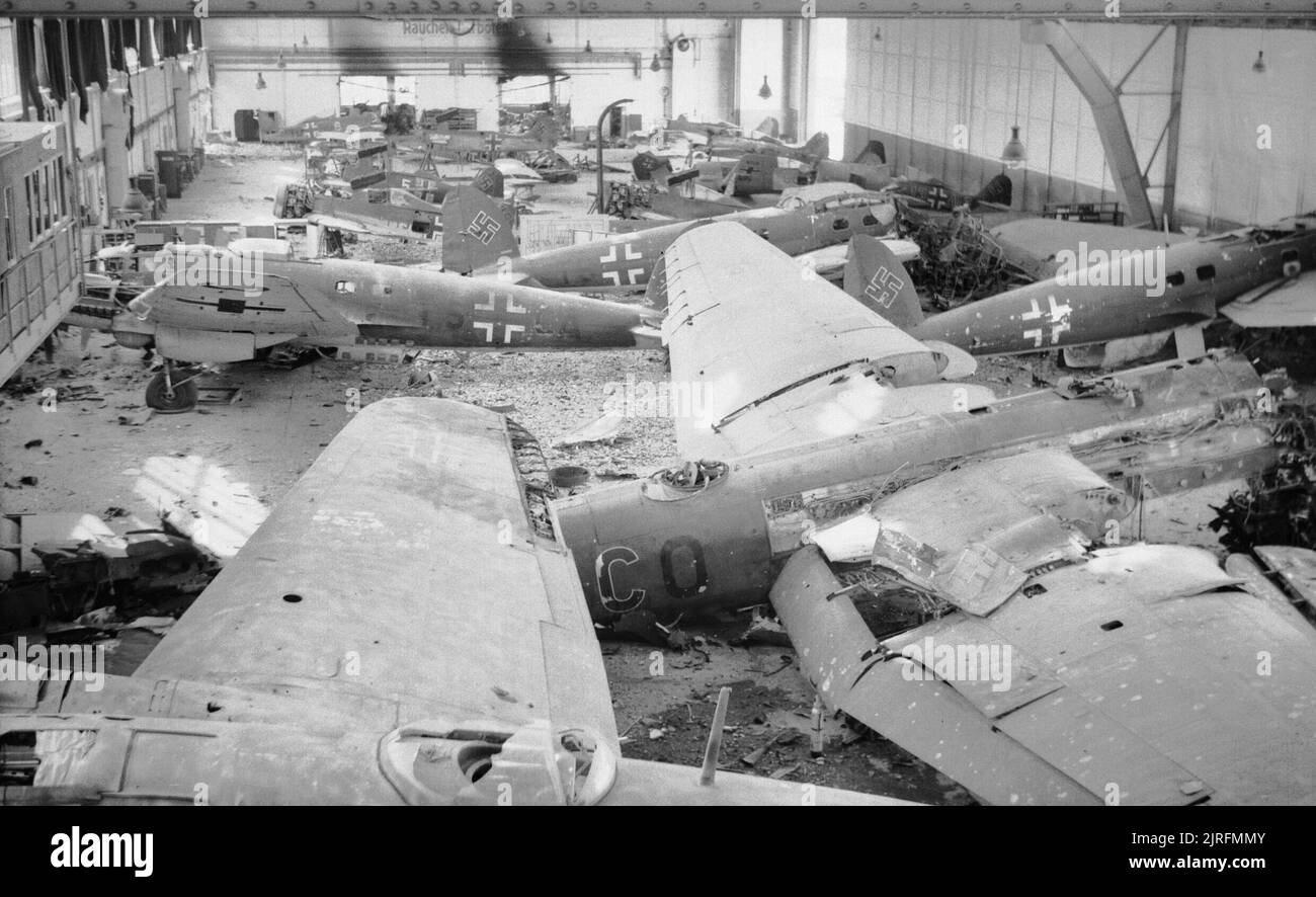 A hangar full of wrecked German aircraft at Schmarbeck airfield, Germany, 20 April 1945. In the foreground are four Heinkel He 111 and one He 177 bombers. In the background are nine Focke-Wulf Fw 190 A fighters. A hangar full of wrecked German aircraft at Schmarbeck airfield, 20 April 1945. In the foreground are four Heinkel He 111 and one He 177 bombers. In the background are nine Focke-Wulf Fw 190 A fighters. Stock Photo