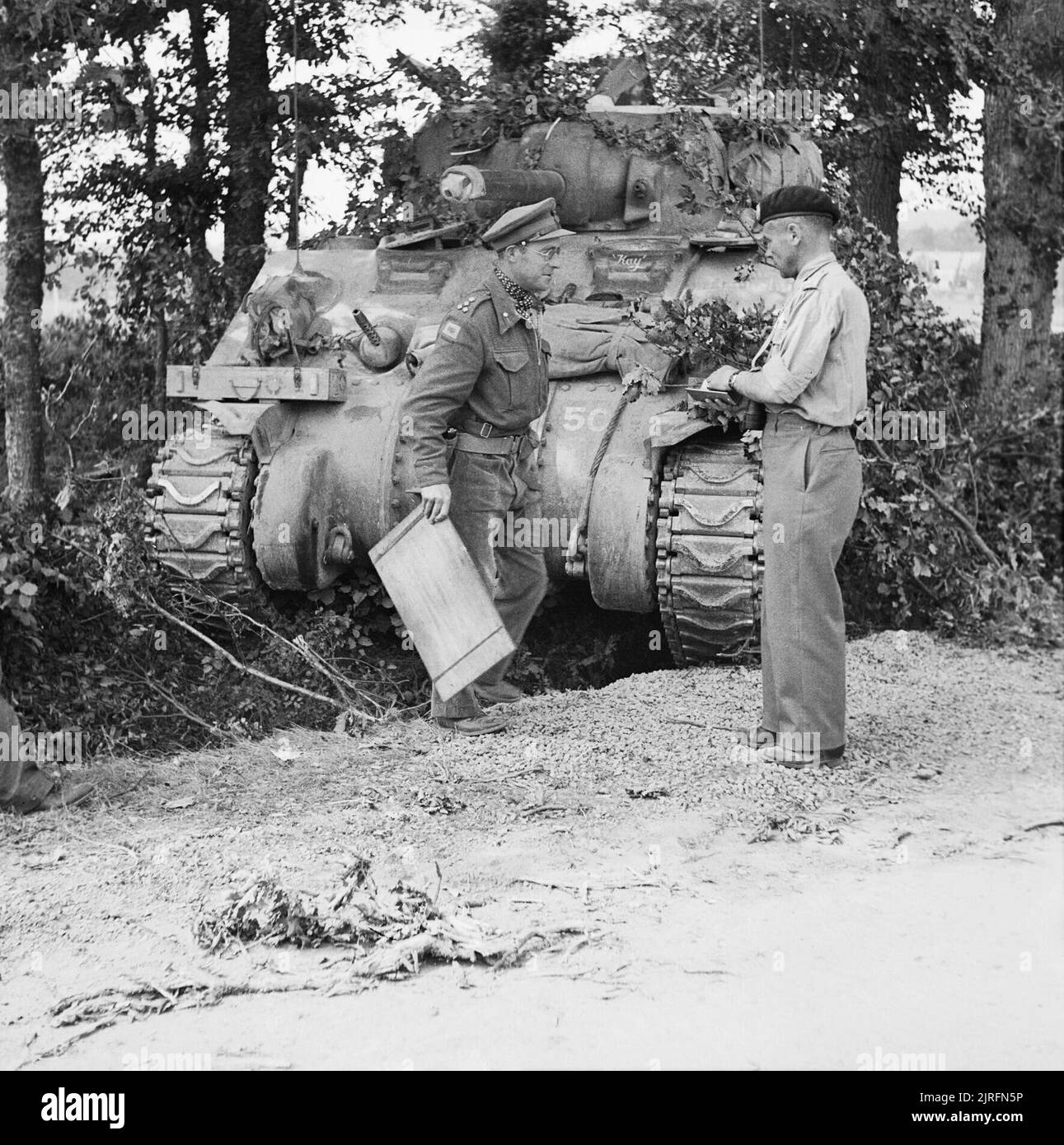 Major General George 'Pip' Roberts (right), commanding 11th Armoured Division, with Brigadier Roscoe Harvey of 29th Armoured Brigade, and a Sherman command tank, Normandy, 15 August 1944. 11th Armoured Division: Major General 'Pip' Roberts, DSO, MC, with Brigadier Harvey, DSO and Bar, at the latter's Sherman command tank, in the forward area. Stock Photo