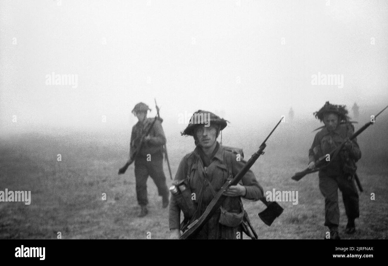 Men of 12 Platoon, 'B' Company, 6th Royal Scots Fusiliers advancing through mist and smoke at the start of Operation 'Epsom', Normandy, 26 June 1944 Men of 12 Platoon, 'B' Company, 6th Royal Scots Fusiliers advancing through mist and smoke at the start of Operation 'Epsom', 26 June 1944. Stock Photo