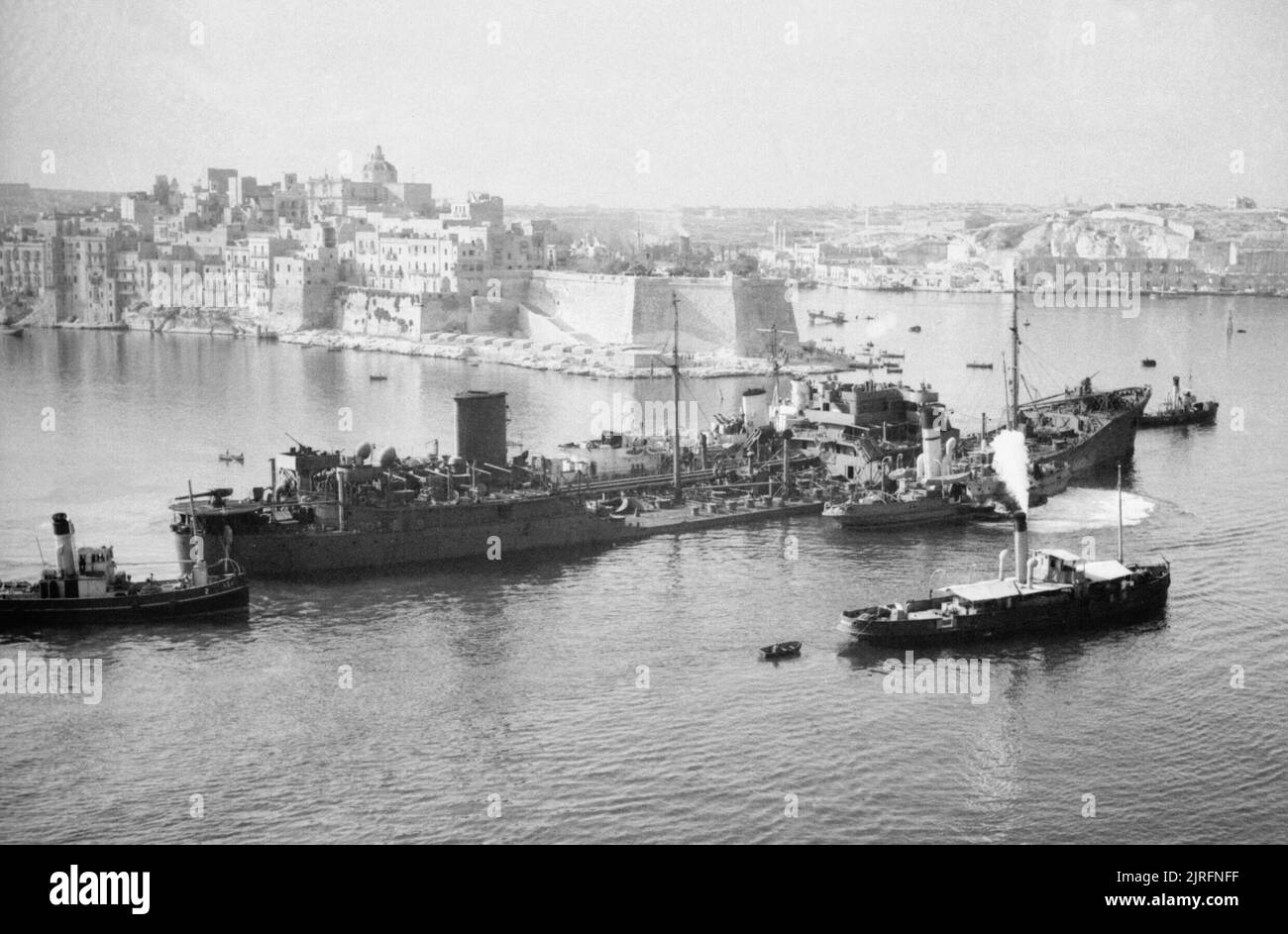 Operation Pedestal and the Siege of Malta, August 1942 The damaged tanker OHIO, supported by Royal Navy destroyers, approaches Malta after an epic voyage across the Mediterranean as part of convoy WS21S (Operation Pedestal) to deliver fuel and other vital supplies to the besieged island. OHIO's back was broken and her engines failed during heavy German and Italian attacks. Because of the vital importance of her cargo (10,000 tons of fuel which would enable the aircraft and submarines based at Malta to return to the offensive), she could not be abandoned. In a highly unusual manoeuvre, two dest Stock Photo