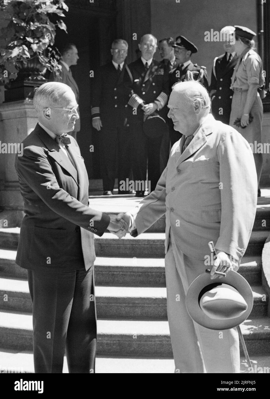 President Harry Truman and Winston Churchill shake hands on the steps of Truman's residence during the Potsdam conference, 16 July 1945. Prime Minister Winston Churchill and US President Harry Truman shake hands on the steps of Truman's residence, 'The White House', at Kaiser Strasse, Babelsberg, Germany, on 16 July 1945. Stock Photo