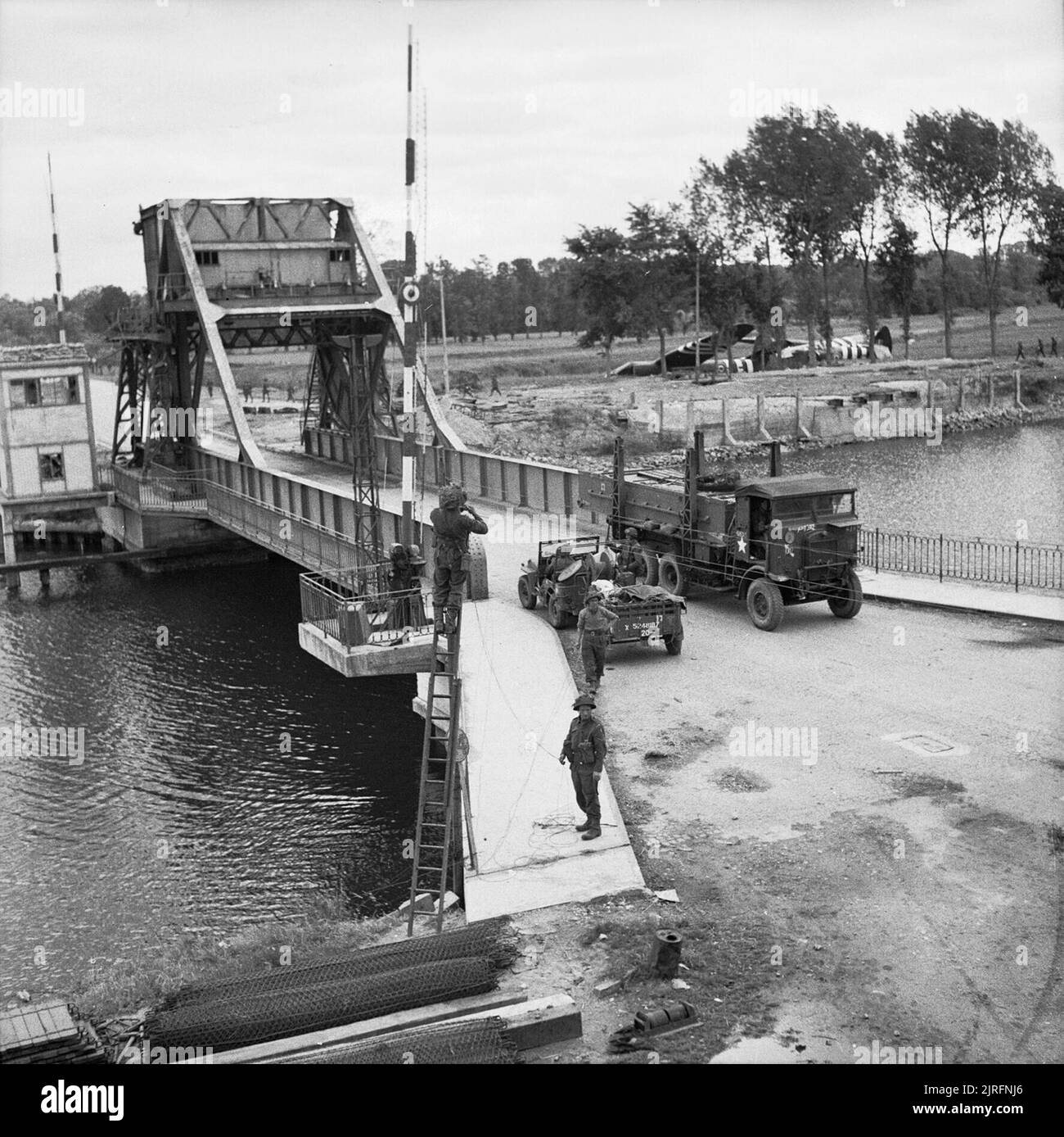 Pegasus Bridge, June 1944 Transport moving across the Caen Canal Bridge at Benouville. The bridge was renamed Pegasus Bridge, after the mythical winged horse on the formation sign of British airborne forces. Stock Photo