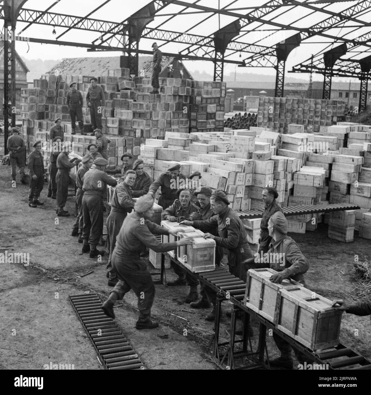 RASC troops stacking ration boxes in the harbour at Dieppe, 14 October 1944. RASC troops stacking ration boxes in the harbour at Dieppe, 14 October 1944. Stock Photo
