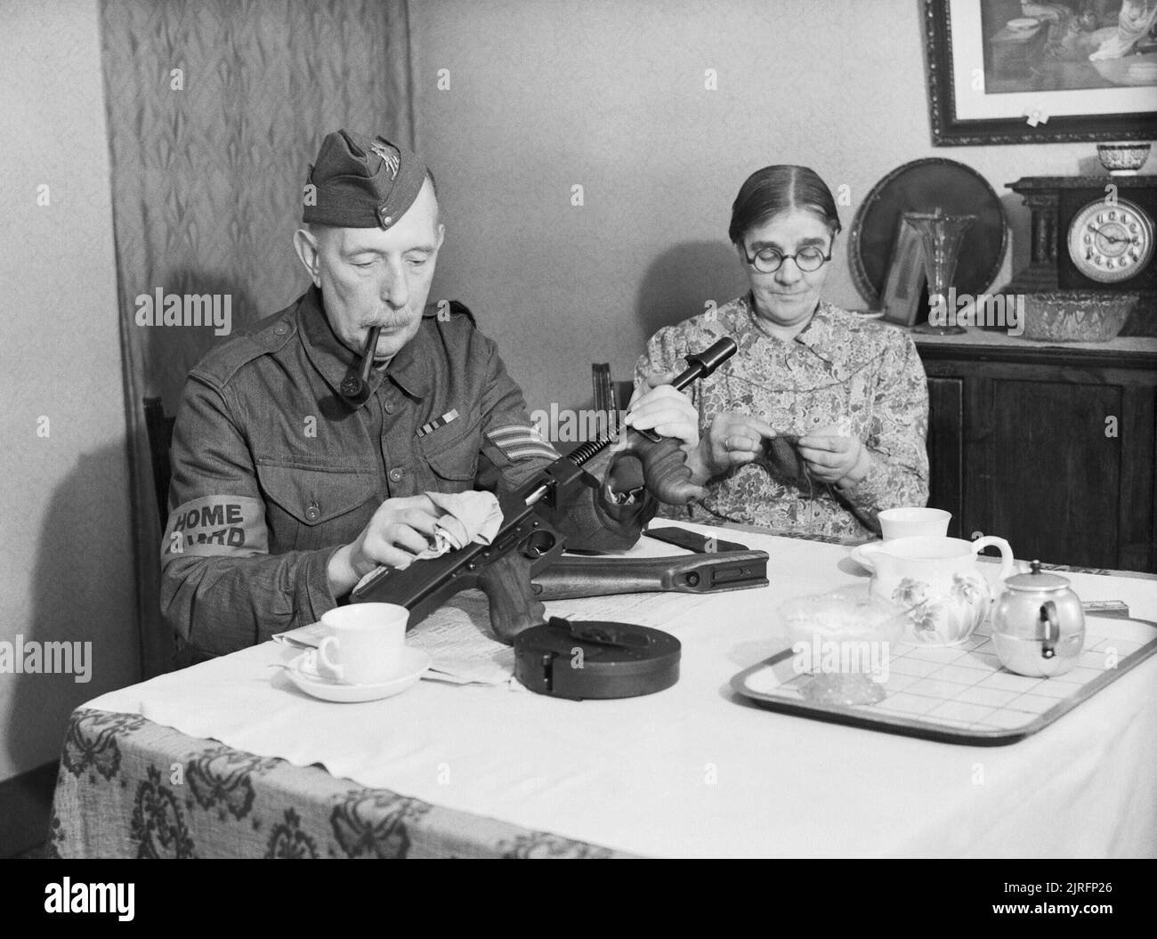 A Veteran Sergeant In The Dorking Home Guard Cleans His Tommy Gun At a-veteran-sergeant-in-the-dorking-home-guard-cleans-his-tommy-gun-at
