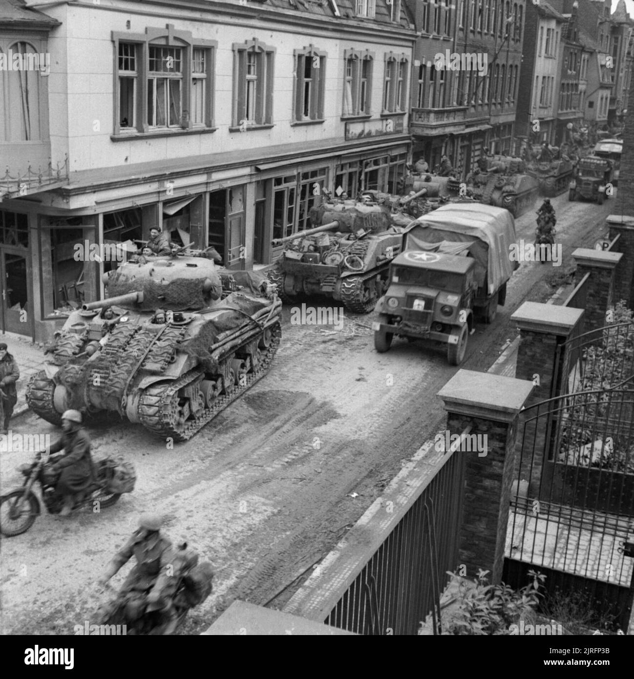 Sherman tanks and transport of 8th Armoured Brigade moving through Kevelaer, Germany, 4 March 1945. Sherman tanks and transport of 8th Armoured Brigade moving through Kevelaer, 4 March 1945. Stock Photo