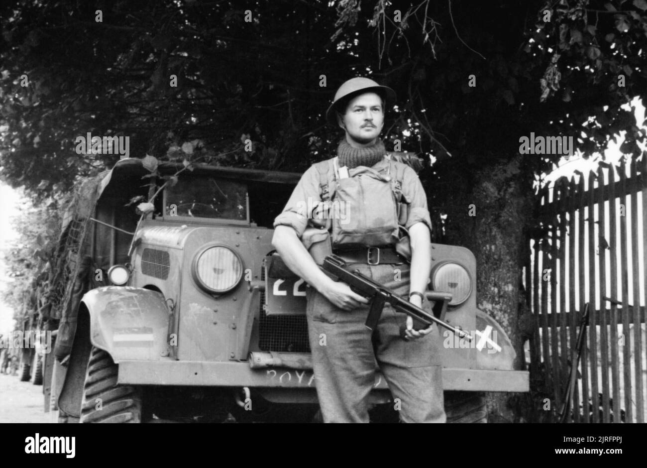 The British Army in France 1940 A soldier of the 52nd Lowland Division poses with his Thompson sub-machine gun and a Bedford MWD truck in France, 13 June 1940. Stock Photo
