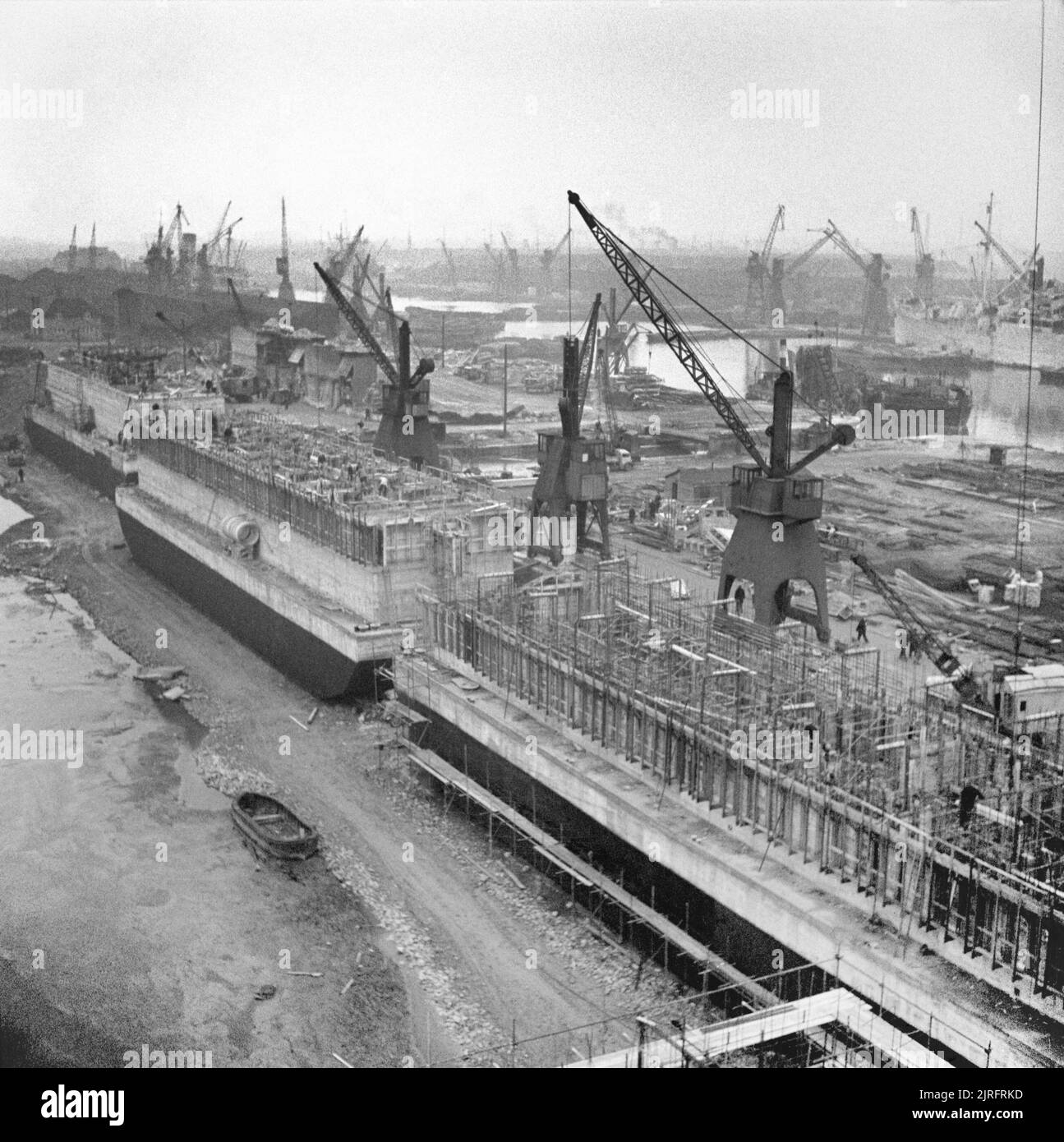 Allied Preparations For D-day 'Phoenix' concrete caissons, part of the Mulberry artificial harbour, being constructed in Surrey Docks in Rotherhithe, London, 17 April 1944. Stock Photo