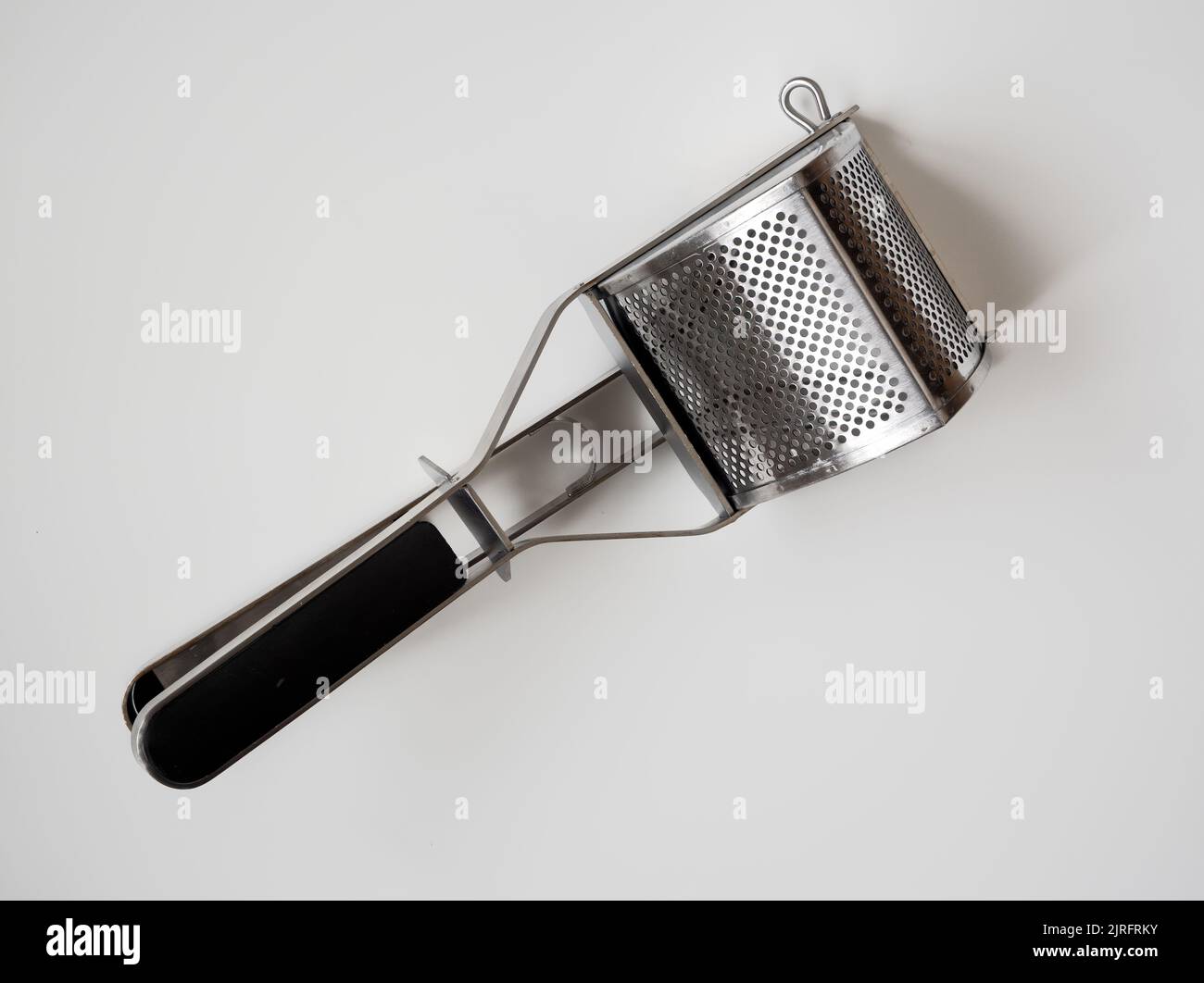 Heavy duty stainless steel mechanical hand potato ricer masher Stock Photo