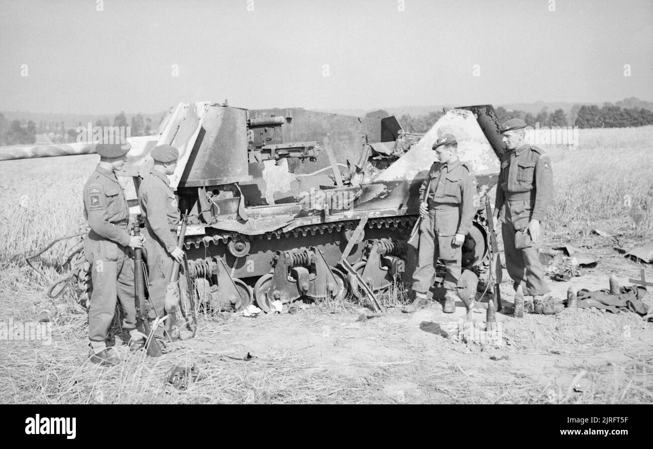 The British Army in Normandy 1944 L/Cpl Phillips, Pte Best, Pte Watson and Cpl Walter of 6th Airborne Division investigate the remains of a German self-propelled gun which they knocked-out, 5 August 1944. (SdKfz 135 Marder on Hotchkiss H39) Stock Photo