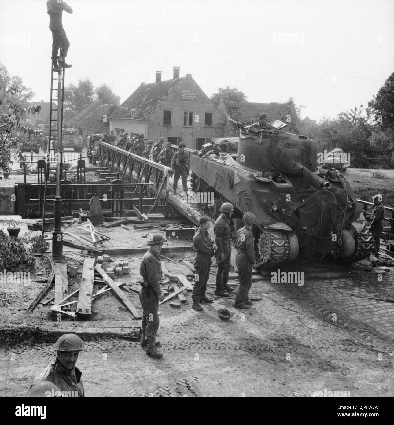 The British Army in North-west Europe 1944-45 A Sherman tank and infantry of 11th Armoured Division cross a canal at Someren in Holland, 24 September 1944. Stock Photo