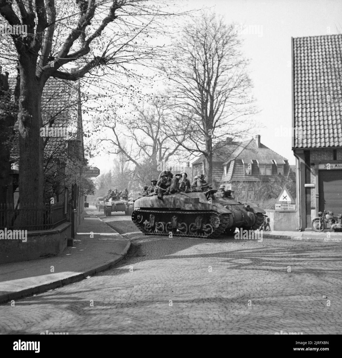 The British Army in North-west Europe 1944-45 Ram Kangaroo personnel carriers passing through Hopsten, 8 April 1945. Stock Photo