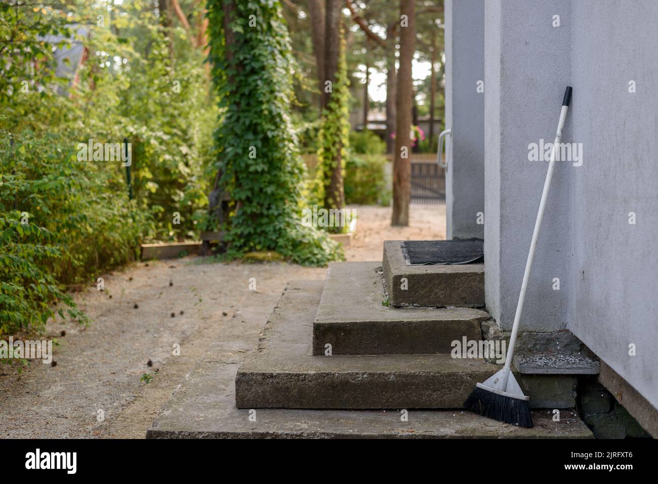 Porch and yard of an estonian modern house with broom near door Stock