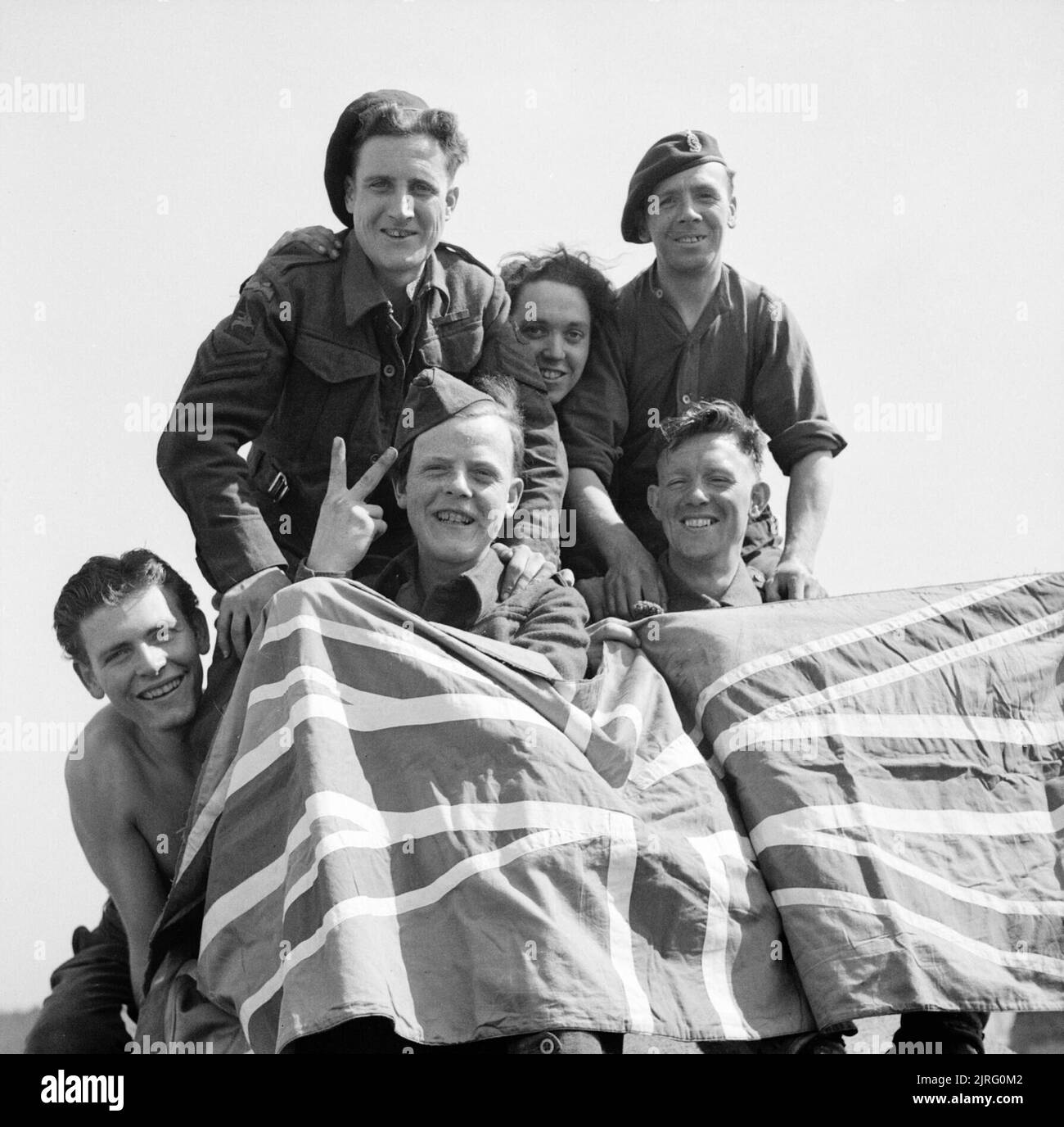 British Prisoners of War celebrate their liberation from Stalag 11B at Fallingbostel, 16 April 1945. Some of the British Prisoners of War liberated from Stalag IIB. From left to right: Private Smyth of Downham, captured at Cherbourg in 1944; Private Ryan of Bradford, captured at Hertogenbosch, 1944; Corporal Beardmore of Cheadle, captured at Arnhem, 1944; Private Still of Manchester, captured at Arnhem, 1944 and Private Greare of Glasgow, captured at St. Valery, 1940. Stock Photo